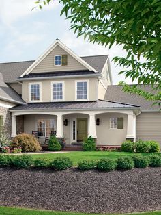 a large house with lots of windows and landscaping