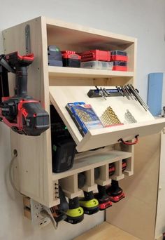 a workbench with various tools and equipment in the cabinet, including drillers