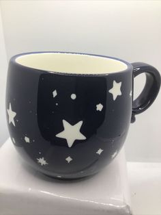 a black and white coffee cup with stars on it