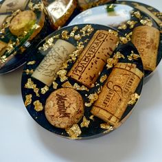 three plates with different types of wine corks and gold flecks on them