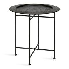 a round metal table with a black tray on it