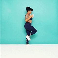 a woman standing in front of a blue wall