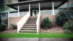 a house with stairs leading up to the front door