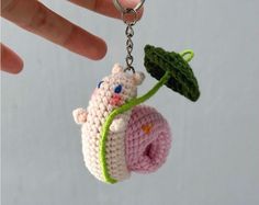 a crocheted keychain with a stuffed animal hanging from it's side