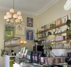 a store with lots of items on shelves and pictures above the counter in front of it