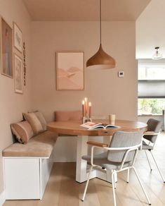 a dining room with a bench, table and chairs