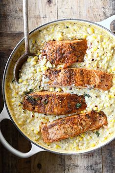 salmon and rice in a skillet on a wooden table