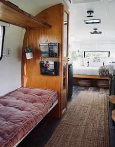 the inside of a camper with a bed in it