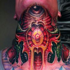 a man with his face covered in tattoos and an eye on the back of his neck