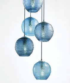 three blue glass balls hanging from the ceiling