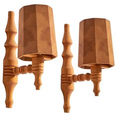 three wooden lamps with shades on them are next to each other, one is turned off