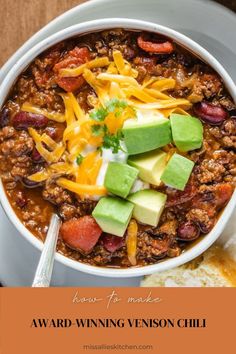 a bowl of chili with cheese, avocado and other toppings on top