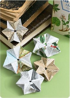 folded origami stars sitting on top of a table next to an open book