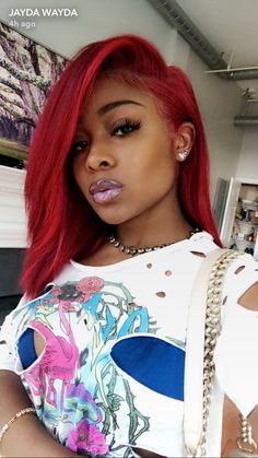 a woman with red hair and piercings on her lips