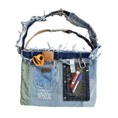 a bag made out of old jeans with some tools sticking out of the back pocket