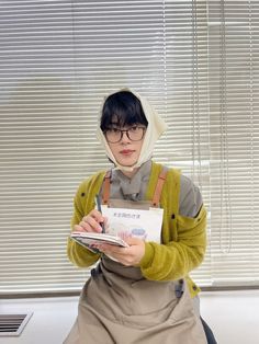 a woman in an apron holding a clipboard and pen