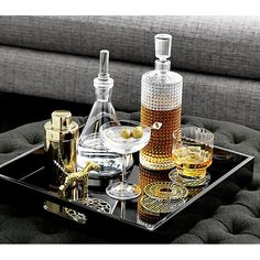 a tray with some bottles and glasses on it