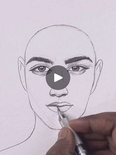 someone is drawing a man's face with a marker