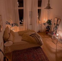 a bed room with a neatly made bed next to two windows and a rug on the floor