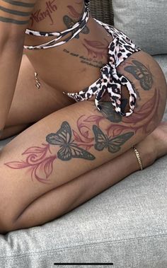 a woman with tattoos sitting on a couch