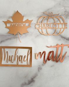 three metal name tags on a marble surface