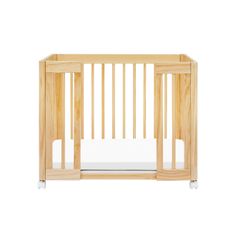 a wooden crib with white sheets on the bottom and side rails, against a white background