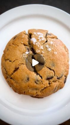 a chocolate chip cookie on a white plate