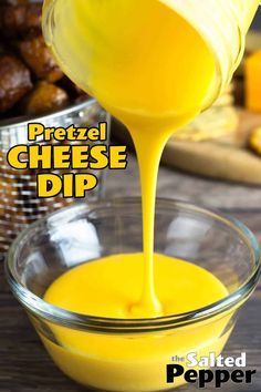 cheese dip being poured into a bowl with pretzel in the background and text overlay that reads pretzel cheese dip