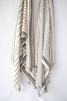 two black and white striped towels hanging on a wall