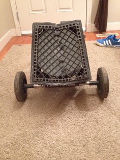 an empty cart sitting on the floor in front of a door