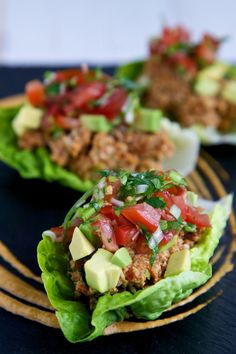 lettuce wraps filled with meat, tomatoes and avocado