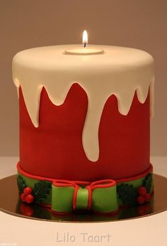 a red and white cake with a candle on top