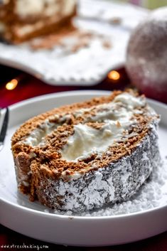 gingerbread cake roll with eggnog cream cheese filling on a white platter