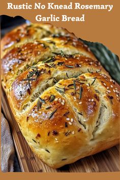 a loaf of garlic bread on a cutting board with the words rustic no knead rosemary garlic bread