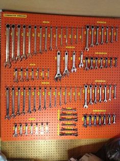 there are many different tools on the pegboard