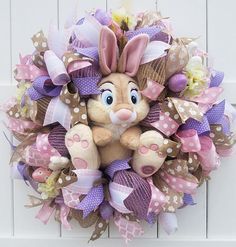 a wreath with a stuffed animal on it