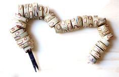 a pair of scissors sitting on top of a table next to some rolled up money