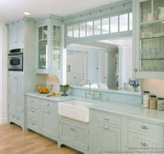 a kitchen with white cabinets and light blue counter tops is pictured in this image from the inside