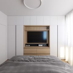 there is a television on the wall above the bed in this modern bedroom with white walls and wood flooring