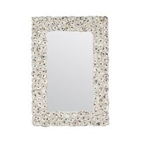 a white square mirror sitting on top of a table