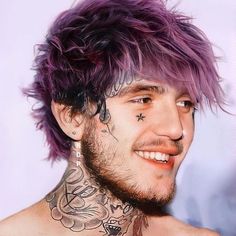 a man with purple hair and tattoos on his chest