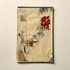 a piece of paper with flowers and letters on it, attached to a wall or ceiling