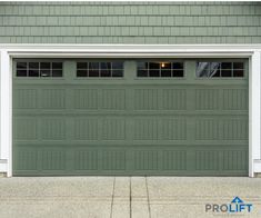 a green garage door with white trim and windows