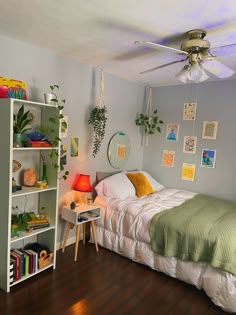 a bed room with a neatly made bed and a book shelf