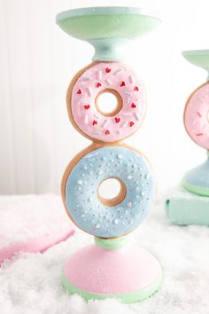 three doughnuts are stacked on top of each other with sprinkles