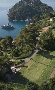 an aerial view of a tennis court in the middle of a large body of water