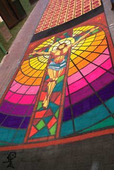 a large stained glass window with a woman on it's body in the center