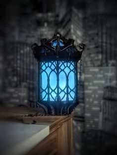 an old - fashioned lantern is lit up in the dark with blue light coming from it