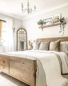 a bedroom with a bed, dresser and mirror in it's centerpieces