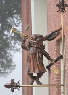 a statue of a rabbit playing the trombone